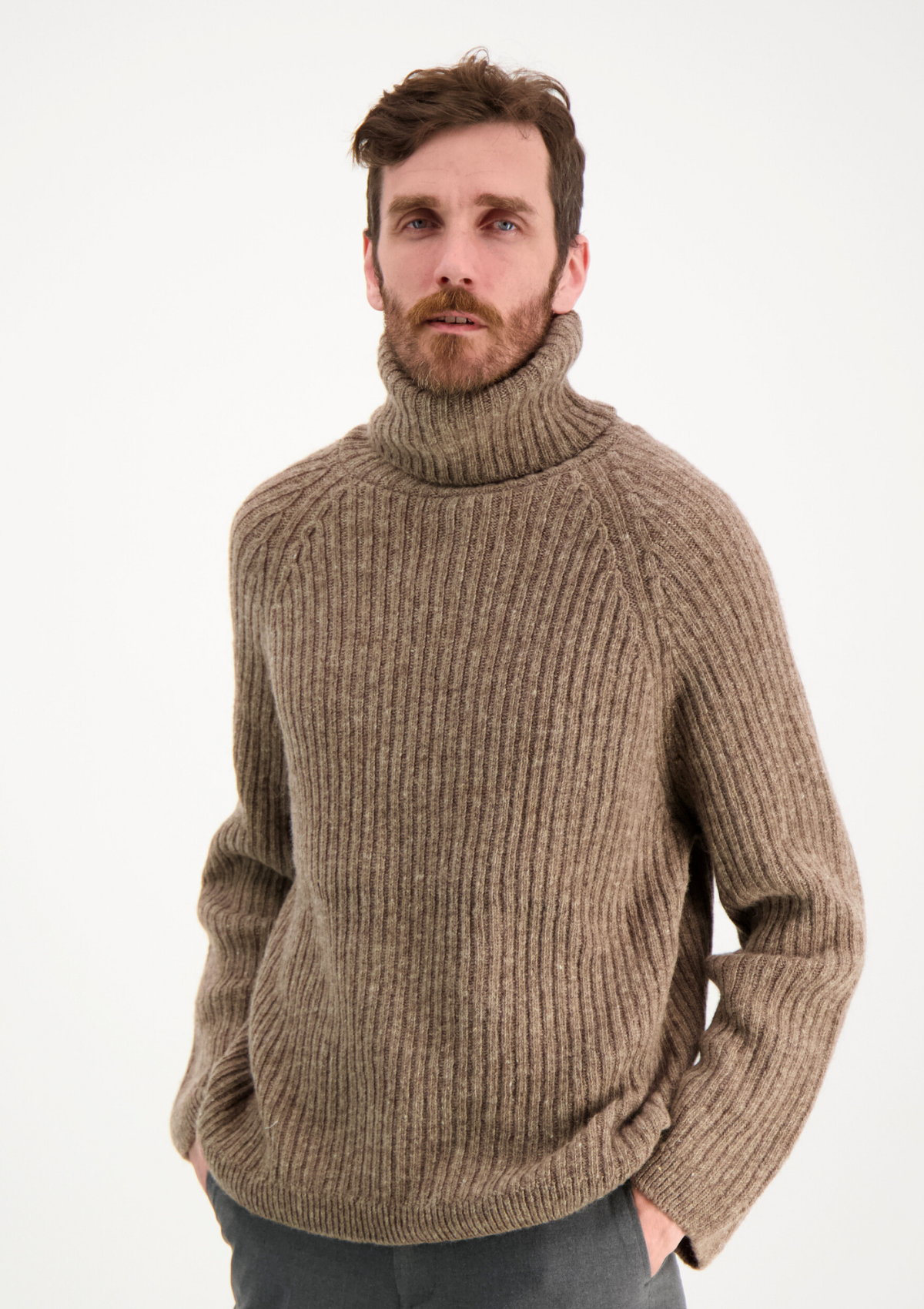 Ribbed beige polo made from Finnish durable sheep wool. Sustainable and warm wool knit made in Finland. 