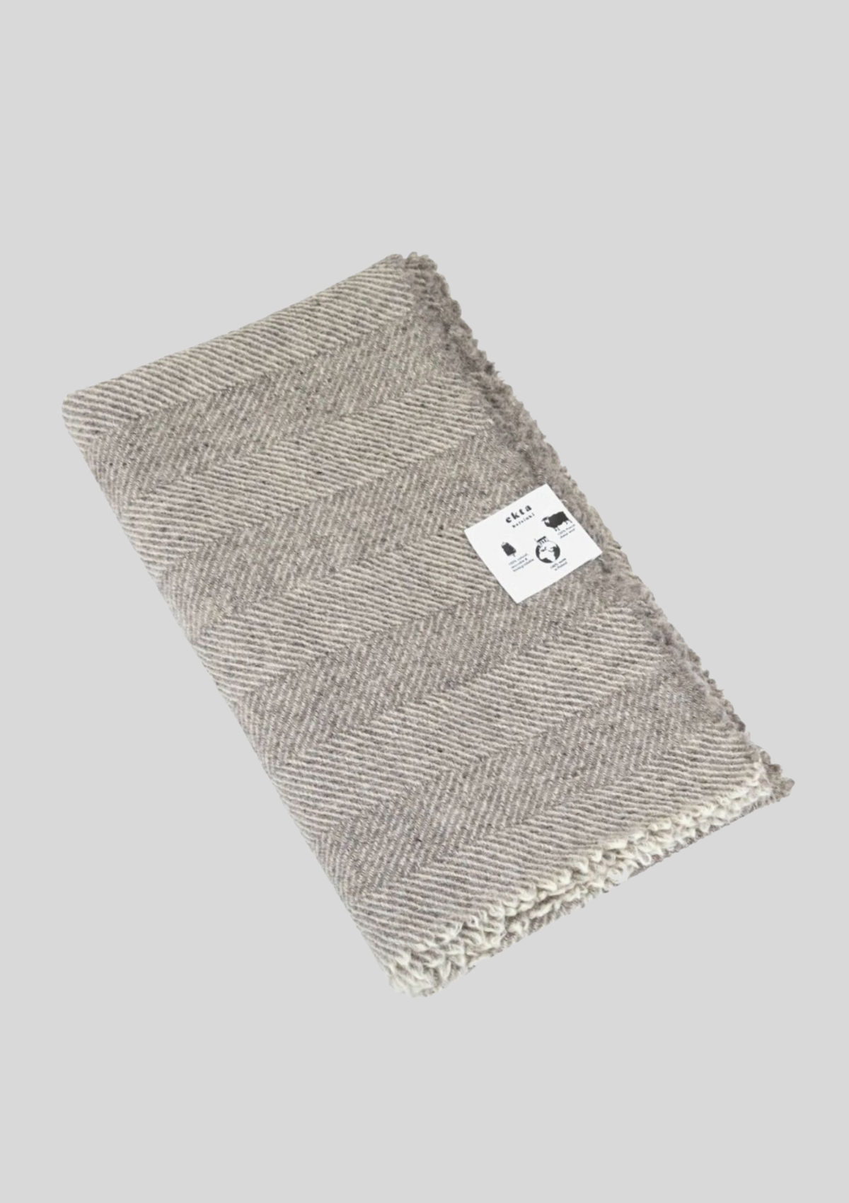 Herringbone pattern white and grey colored throw made out of responsible Finnish sheep wool. Manufactured in Finland.  