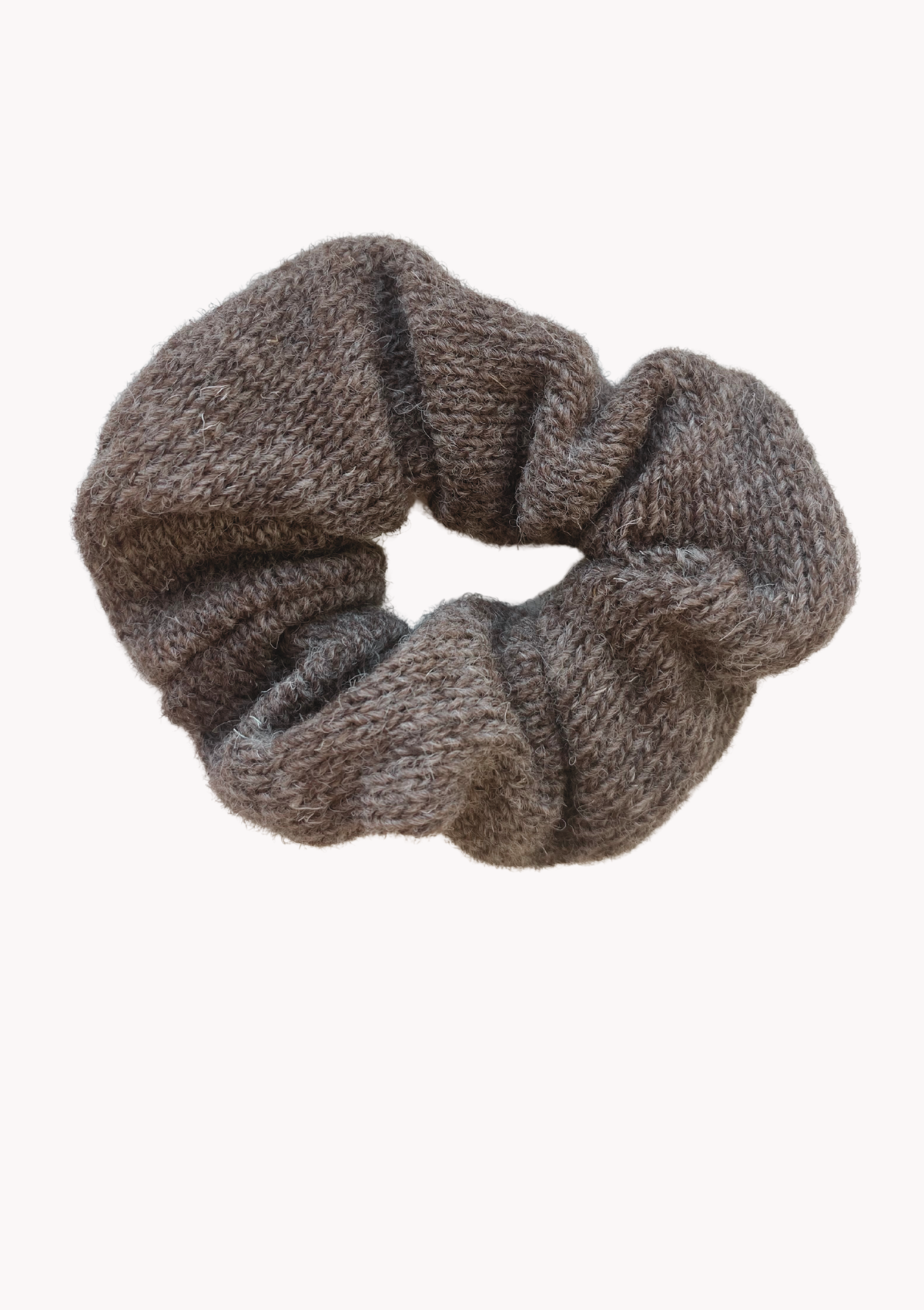 A wool scrunchie that is gentle and warm for the hair and head. Made in Helsinki, material Finnish sheep wool. Comes in beige and brown. 