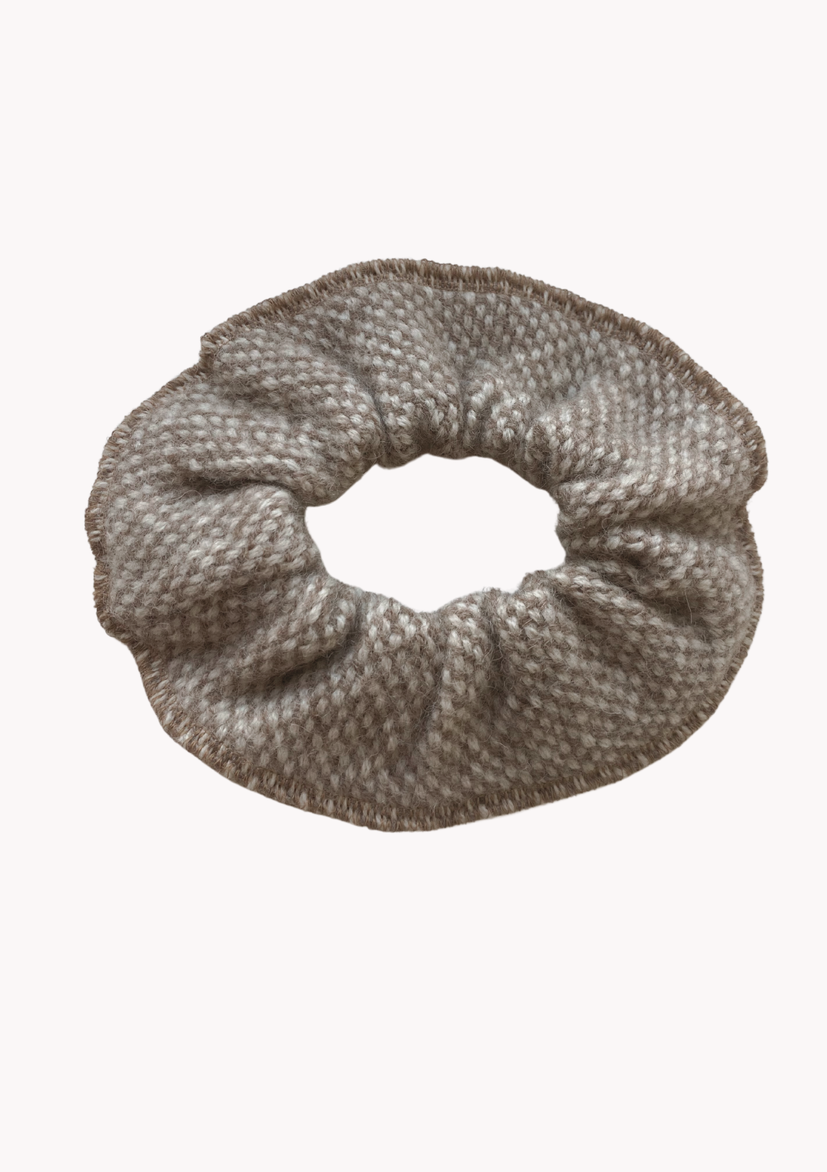 Wool scrunchie that is gentle and warm for the hair and head. Made in Helsinki, material Finnish sheep wool. Comes in beige tones in a checkered and dotted pattern. 